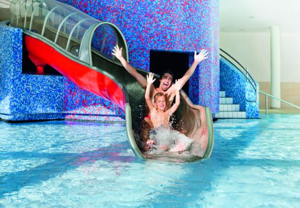 Family sliding down the water slide