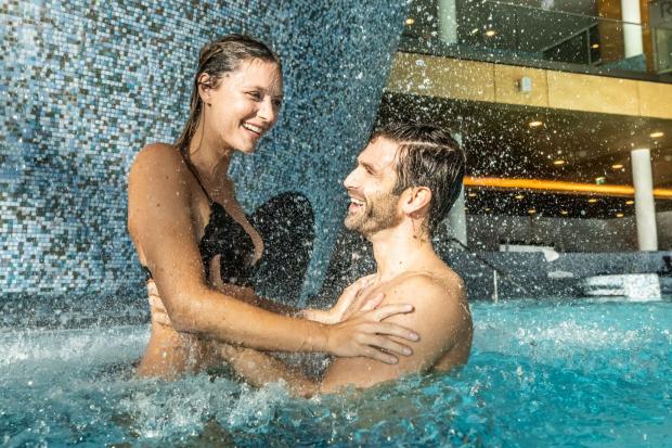 A couple enjoying an indoor pool